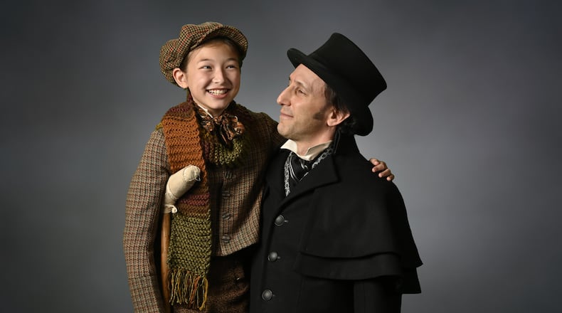 Chloe Gia Bremer (left) as Tiny Tim and Andrew Benator as Ebeneezer Scrooge are part of a new adaptation of "A Christmas Carol" at the Alliance Theatre. Photo: courtesy the Alliance Theatre