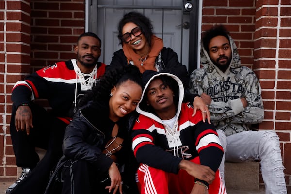 Children of the Dungeon family pose for a portrait in front of the family home in Atlanta on Feb. 17. Natrice Miller/AJC