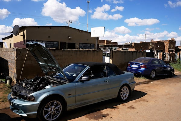 Cars to be repaired are parked outside the workshop of Themba Maseko, a 39-year-old mechanic, in Brakpan, east of Johannesburg, South Africa, Wednesday, April 30, 2025. (AP Photo/Themba Hadebe)