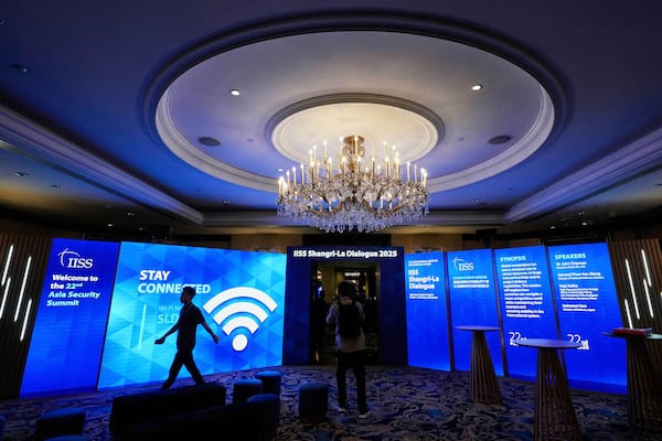 A worker walks inside a hall at the venue of 22nd Shangri-La Dialogue summit in Singapore, Thursday, May 29, 2025. (AP Photo/Anupam Nath)
