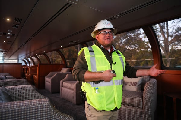 Senior general supervisor Christopher Bailey gives a tour of the cars in the train during Tracks of Hope. Norfolk Southern soon plans to file for regulatory approval of an acquisition by Union Pacific. The newly combined company would be headquartered in Omaha. (Abbey Cutrer/AJC)