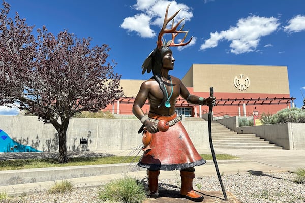 A statue is seen in front of the Institute for American Indian Arts during summer recess in Santa Fe, N.M., Saturday, June 7, 2025, as Congress proposes a cut-off in annual federal spending allocations to the tribal college. (AP Photo/Morgan Lee)