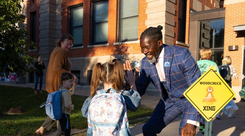 FILE - Ian Roberts, superintendent of Des Moines Public Schools, greets students at Greenwood Elementary School in Des Moines, Aug. 25, 2025. (Jon Lemons/Des Moines Public Schools via AP)