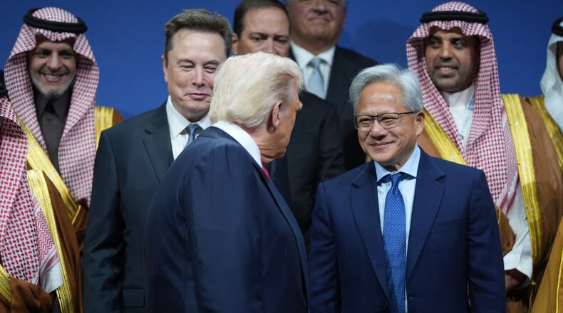 President Donald Trump speaks with Elon Musk and Nvidia CEO Jensen Huang, during the Saudi Investment Forum at the Kennedy Center, Wednesday, Nov. 19, 2025, in Washington. (AP Photo/Evan Vucci)