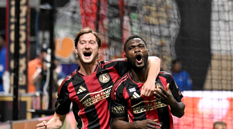 Atlanta United forward Emmanuel Latte Lath (19) celebrates with Atlanta United midfielder Aleksey Miranchuk (left) after scoring during the first half of Atlanta United’s MLS season opener at Mercedes-Benz Stadium, Saturday, February 22, 2025, in Atlanta. (Hyosub Shin / AJC)