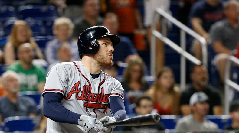 Atlanta Braves' Freddie Freeman watches his home run during the first inning of a baseball game against the Miami Marlins, Saturday, May 12, 2018, in Miami. (AP Photo/Wilfredo Lee)