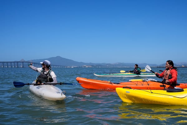 Casey Stewart, left, directs a delegation of Indigenous leaders from Ecuador on a path to kayak and see the Chevron Long Wharf, Thursday, June 19, 2025, in Richmond, Calif. (AP Photo/Godofredo A. Vásquez)