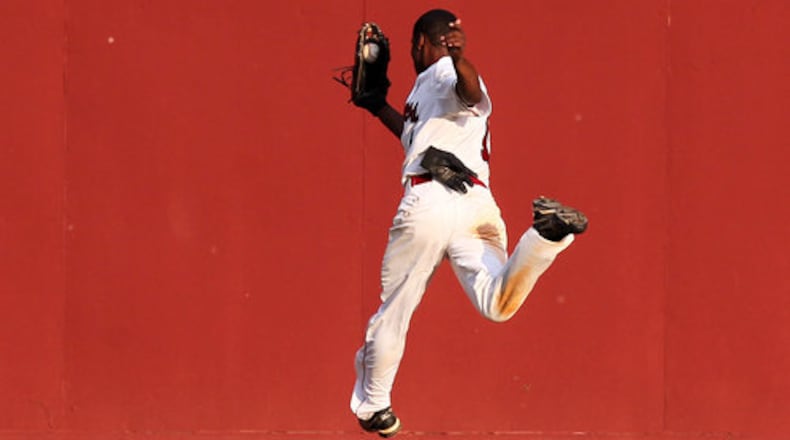 Brookwood centerfielder Cedric Mullins makes a over-the-shoulder catch on a dead run for the out on a deep fly ball by Grayson's Jeril Dawson during 1st inning action in game two of a double header at Brookwood High School in Snellville on Monday, May 21, 2012.