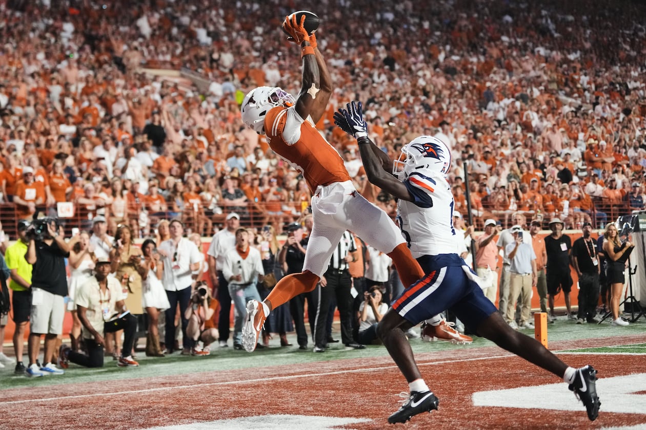 Texas wide receiver Cam Coleman, left, catches a touchdown pass as UTSA cornerback RJ Lester Jr., right, defends during the first half of an NCAA college football game in Austin, Texas, Saturday, Sept. 19, 2026. (AP Photo/Eric Gay)