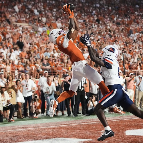 Texas wide receiver Cam Coleman, left, catches a touchdown pass as UTSA cornerback RJ Lester Jr., right, defends during the first half of an NCAA college football game in Austin, Texas, Saturday, Sept. 19, 2026. (AP Photo/Eric Gay)