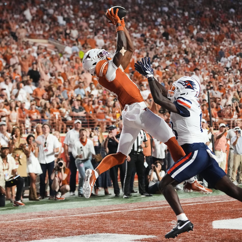 Texas wide receiver Cam Coleman, left, catches a touchdown pass as UTSA cornerback RJ Lester Jr., right, defends during the first half of an NCAA college football game in Austin, Texas, Saturday, Sept. 19, 2026. (AP Photo/Eric Gay)