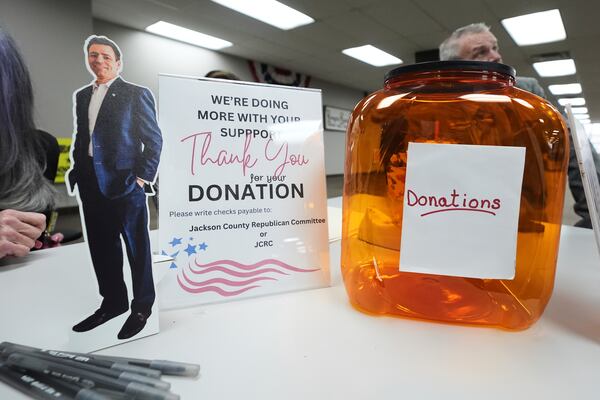 A small cutout of Ryan Kelley sits on the registration table before his talk at the Jackson County Republican headquarters, Thursday, April 10, 2025, in Jackson, Mich. (AP Photo/Paul Sancya)