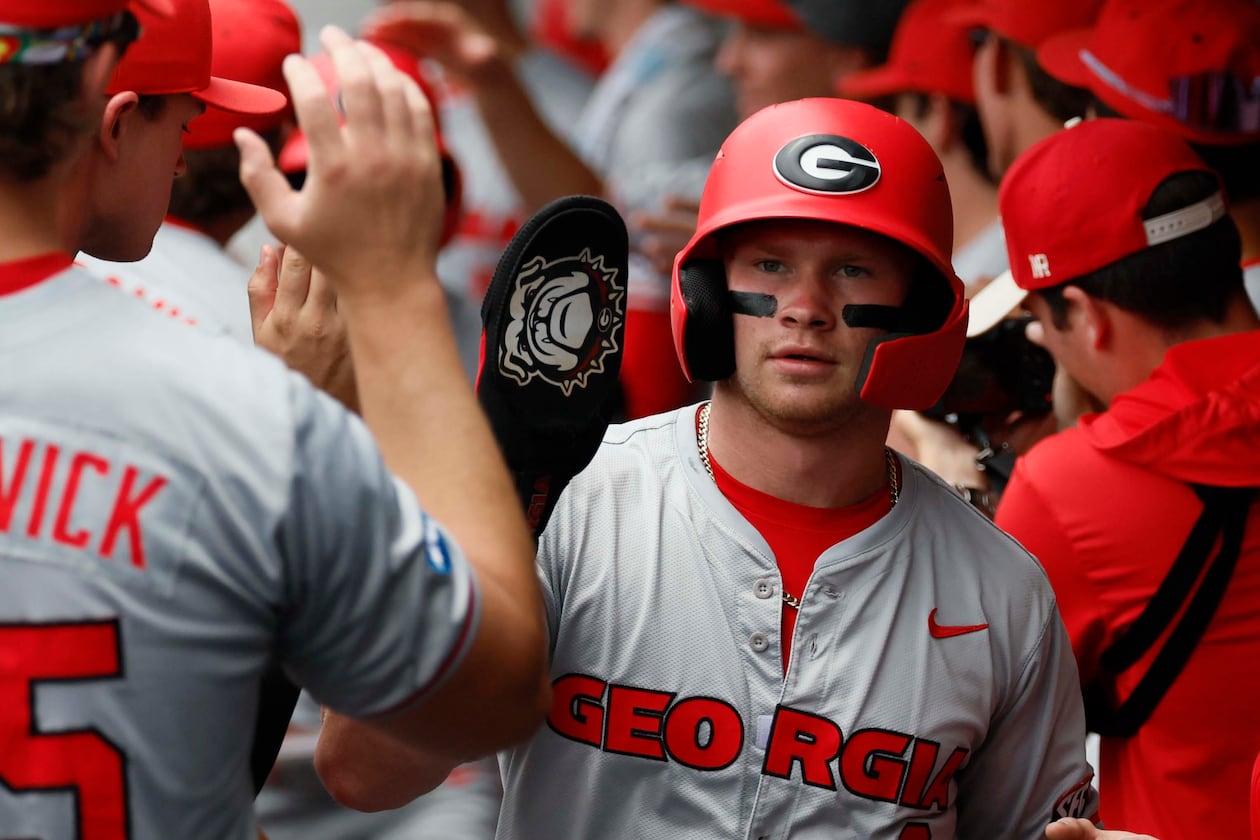 Georgia Bulldogs catcher Daniel Jackson high-fives teammates after scoring during the first inning of Game 2 of the NCAA Super Regional at Foley Field on Sunday, June 7, 2026, in Athens. (Miguel Martinez/AJC)
