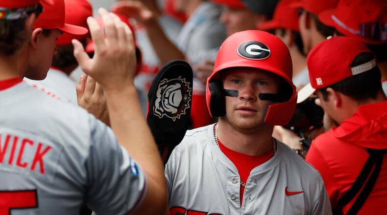 Georgia Bulldogs catcher Daniel Jackson high-fives teammates after scoring during the first inning of Game 2 of the NCAA Super Regional at Foley Field on Sunday, June 7, 2026, in Athens. (Miguel Martinez/AJC)