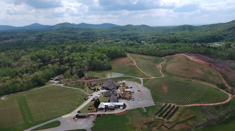 April 18, 2019 Cleveland - Aerial photo of Yonah Mountain Vineyards where solar panels (foreground right) were installed in Cleveland on Wednesday, April 18, 2019. Yonah Mountain Vineyards is the first winery in Georgia to implement a major solar power initiative with the goal of countering its carbon footprint. It is currently the only winery in the Southeast with a program of this size generating at least 60% of its total annual energy usage. HYOSUB SHIN / HSHIN@AJC.COM