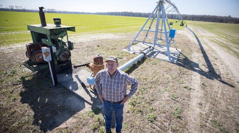Ray Davis, a Bulloch County farmer, stands near one of his wells and pivots that irrigate part of his 1,100 acres on Wednesday, Feb. 21, 2024,  near Brooklet, Ga. Davis is concerned that a plan to pump groundwater to supply Hyundai's Metaplant EV factory will compromise local wells like his. (AJC Photo/Stephen B. Morton)