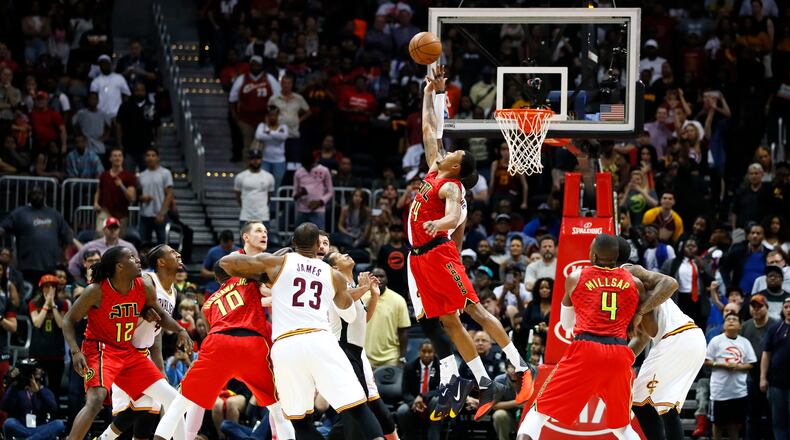 Atlanta Hawks forward Kent Bazemore (24) goes up for the jump ball in the final seconds of the second half of an NBA basketball game against the Cleveland Cavaliers on Sunday, April 9, 2017, in Atlanta. The Hawks won in overtime 126-125. (AP Photo/Todd Kirkland)