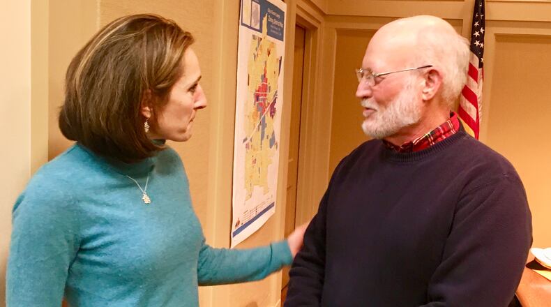 Mayor Pro Tem Fred Boykin and his successor Kelly Walsh chat after Boykin’s final city commission meeting on Dec. 18. Boykin has been a commissioner since 2000. Bill Banks for the AJC
