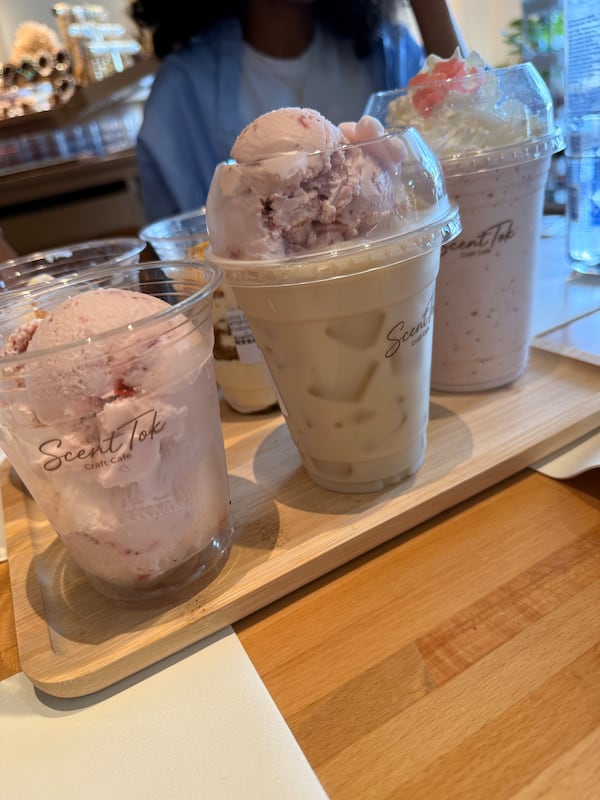 A lineup of three milkshakes in plastic cups