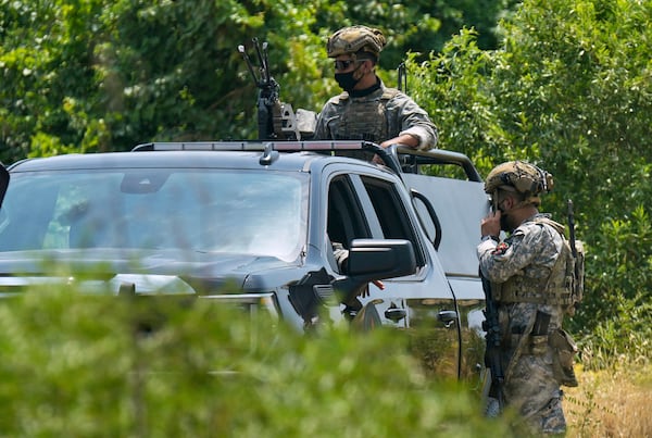Forces of the regional Kurdish administration secure the area of the Jasana Cave ahead of a symbolic disarmament ceremony by the separatist PKK group as part of the peace process with Turkey, in Sulaymaniyah governorate, Iraq, Friday, July 11, 2025. (AP Photo/Hadi Mizban)