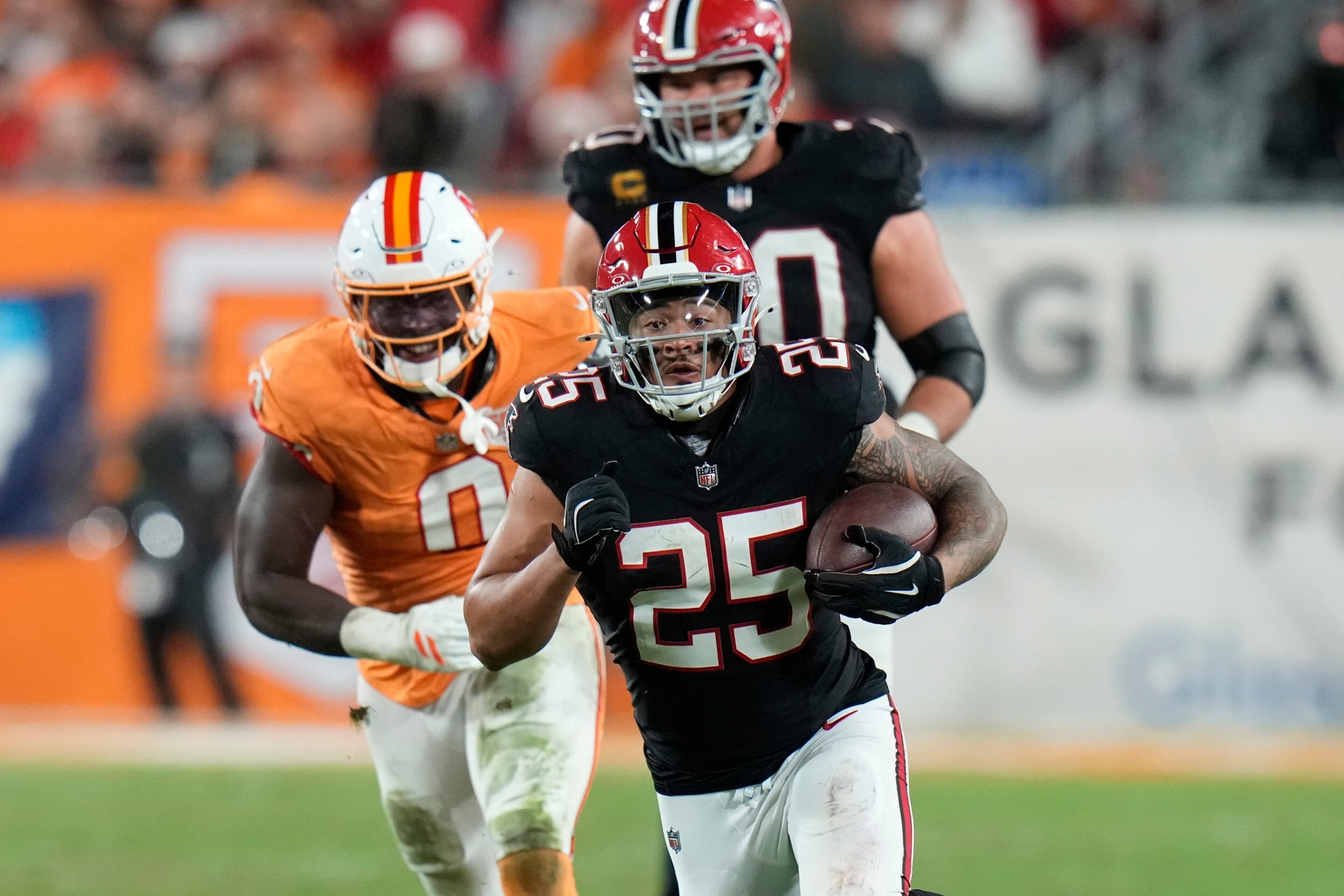 Atlanta Falcons running back Tyler Allgeier (25) runs against the Tampa Bay Buccaneers during the second half of an NFL football game, Thursday, Dec. 11, 2025, in Tampa, Fla. (AP Photo/Chris O'Meara)