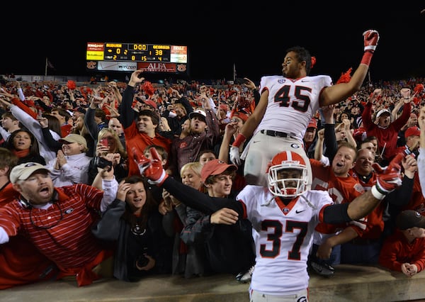 University of Georgia linebacker Christian Robinson (in crowd) — pictured celebrating a UGA win in 2012 — brought the team's entire defensive line to Weaver D's when he was a student. "(It) is one of those spots everybody wants to come be a part of,” Robinson said. (Brant Sanderlin/AJC 2012)