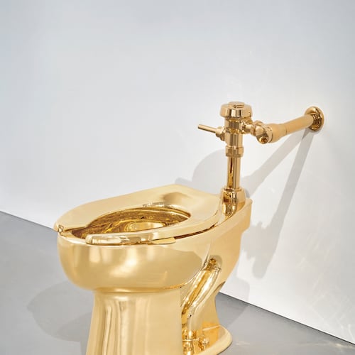 Sotheby’s has announced it will auction a solid gold toilet, a sculpture by Italian artist Maurizio Cattelan called “America.” The auction is set for Nov. 18 in New York. (Sotheby via AP)