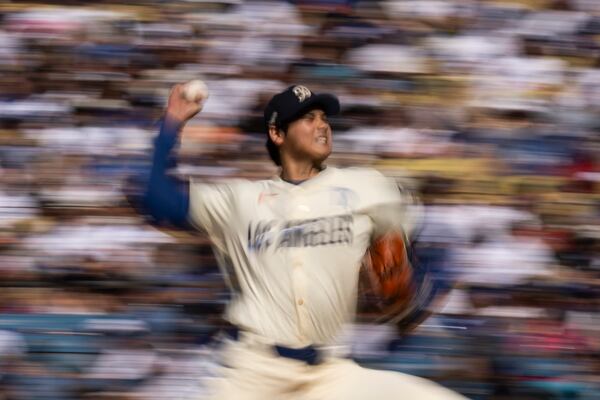 Los Angeles Dodgers starting pitcher Shohei Ohtani delivers during the first inning of a baseball game against the Houston Astros in Los Angeles, Saturday, July 5, 2025. (AP Photo/Kyusung Gong)