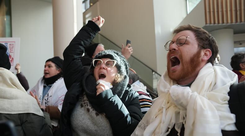 Protesters against Federal immigration agents gather at Target, Friday, Jan. 23, 2026, in Minneapolis. (AP Photo/Abbie Parr)