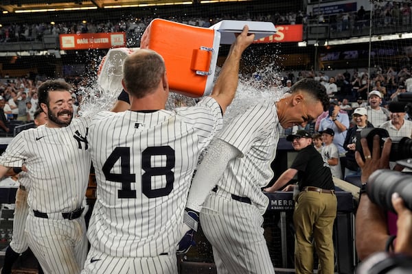 New York Yankees players throw Gatorade on designated hitter Aaron Judge after winning a baseball game against the Seattle Mariners, Thursday, July 10, 2025, in New York. (AP Photo/Yuki Iwamura)