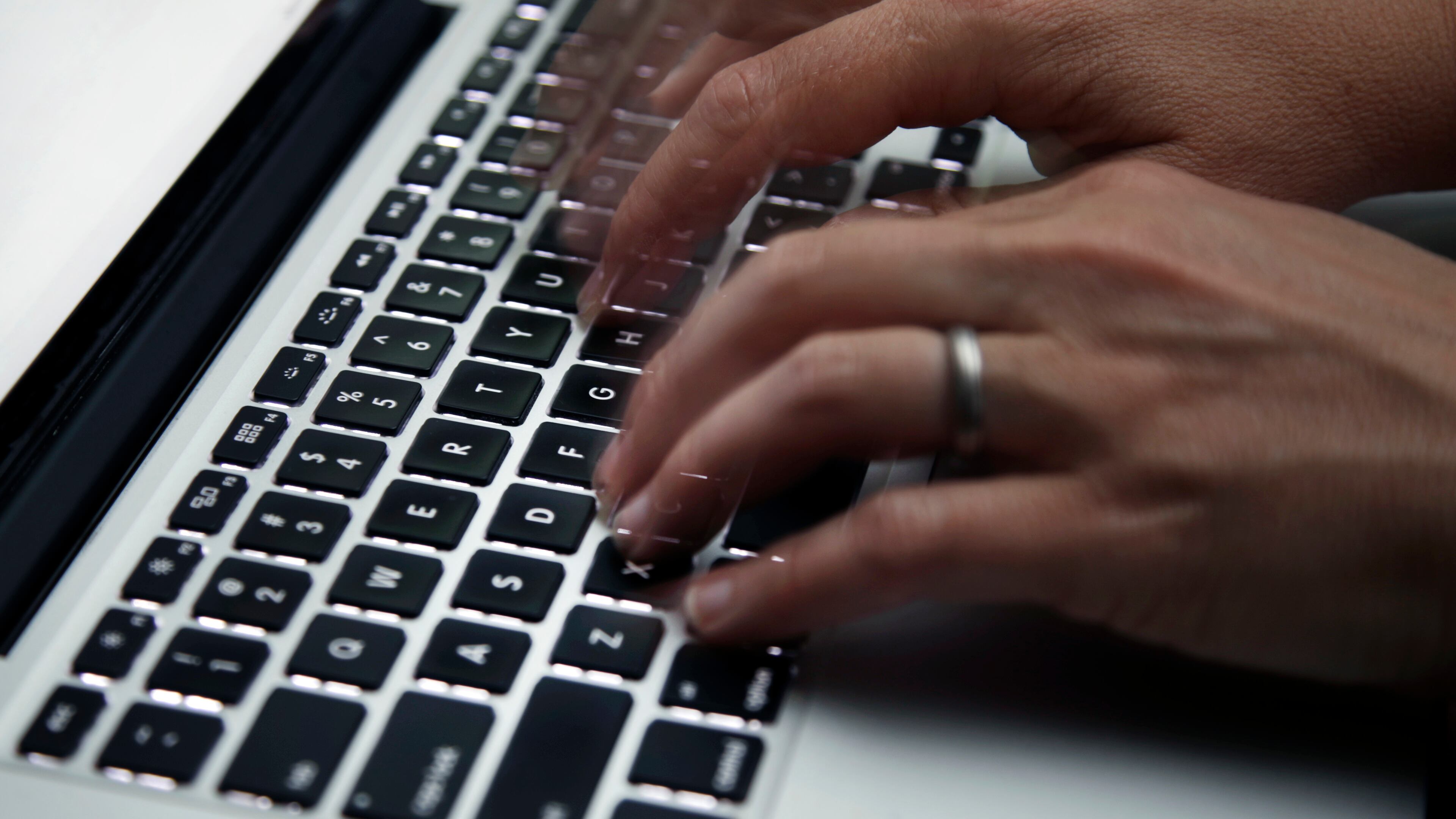 FILE - A person working on a laptop in North Andover, Mass., June 19, 2017. (AP Photo/Elise Amendola, File)
