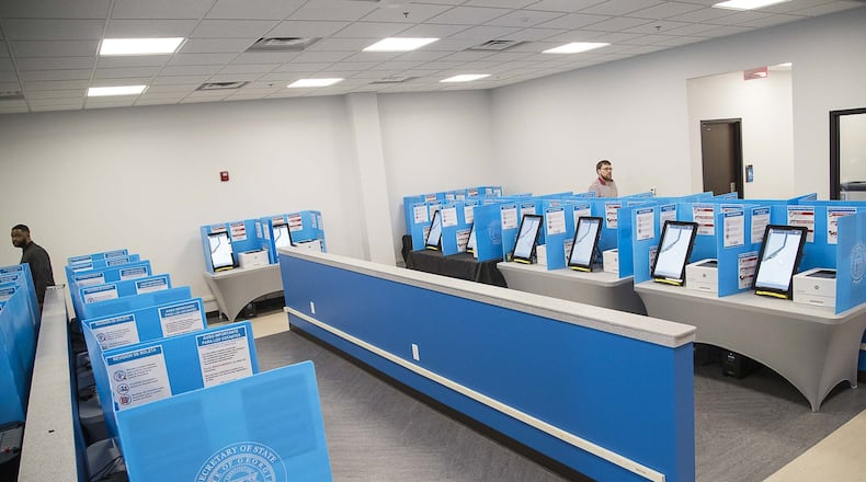 03/02/2020 — Lawrenceville, Georgia — Gwinnett County poll workers walk through the voting area at the Gwinnett County Voter Registrations and Elections office building during early voting for the presidential primary in Lawrenceville, Monday, March 2, 2020. (ALYSSA POINTER/ALYSSA.POINTER@AJC.COM)
