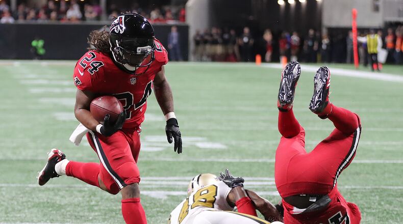 December 7, 2017 Atlanta: Falcons fullback Derrick Coleman levels Saints safety Vonn Bell opening the hole for running back Devonta Freeman to score a touchdown to take a 10-3 lead during the second quarter in a NFL football game on Thursday, December 7, 2017, in Atlanta. Curtis Compton/ccompton@ajc.com