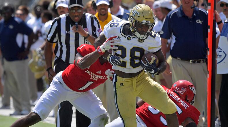 Georgia Tech running back J.J. Green (28) runs down the sidelines until he is pushed out by Jacksonville State safety Marlon Bridges (1) in the first half of the Georgia Tech home opener at Bobby Dodd Stadium on Saturday, September 9, 2017.  HYOSUB SHIN / HSHIN@AJC.COM