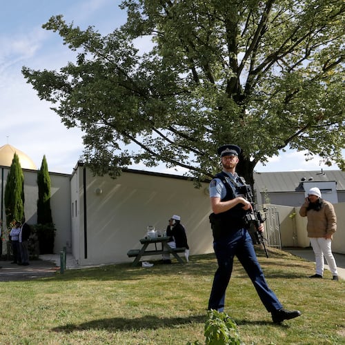 FILE - An armed policeman patrols the grounds at the Al Noor mosque following the previous week's mass shooting in Christchurch, New Zealand, on March 23, 2019. (AP Photo/Mark Baker, File)