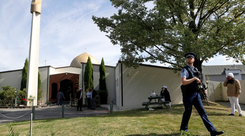 FILE - An armed policeman patrols the grounds at the Al Noor mosque following the previous week's mass shooting in Christchurch, New Zealand, on March 23, 2019. (AP Photo/Mark Baker, File)
