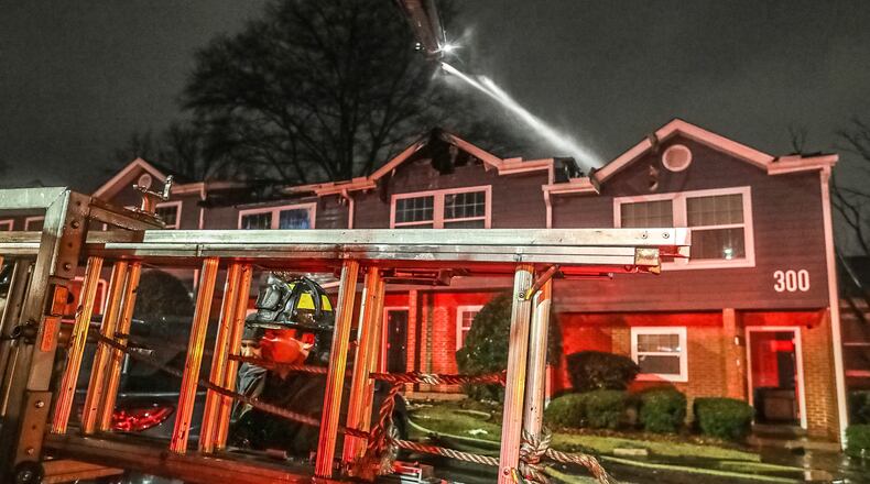 Atlanta firefighters worked for hours to douse hotspots after a Thursday morning two-alarm fire at an apartment complex off Richardson Street in the Mechanicsville neighborhood of Atlanta. (John Spink / John.Spink@ajc.com)