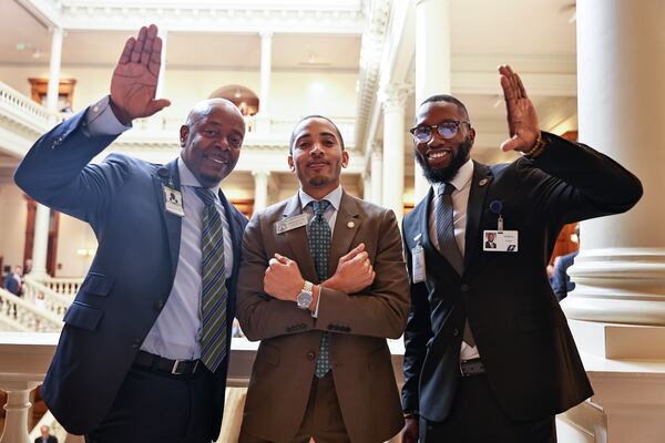 (Left to right) Chris McCrary, Rep. Omari Crawford and DeMetris Causer hold up Omega Psi Phi Fraternity Inc. hand signs at the Georgia Capitol in 2023. (Natrice Miller/natrice.miller@ajc.com)