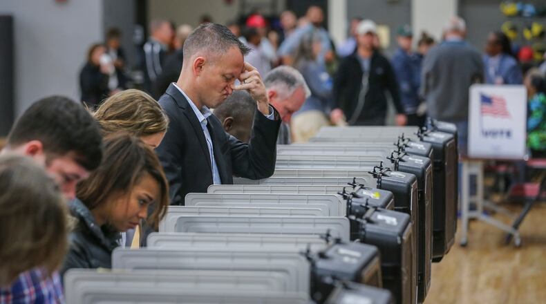November 8, 2016 Atlanta: Aaron Coe had a disgruntled expression on his face as he voted on Tuesday, Nov. 8, 2016 at Henry W. Grady High School at 929 Charles Allen Dr NE in Atlanta. ÒIÕm pleased to say all the polls opened on time and on schedule," Fulton elections director Richard Barron told The AJC. "WeÕre expecting 70 percent turnout."ÊÊThe previous early voting record in 2012 was 152,562. When absentee ballots come in, Barron said he expects the early vote will be about 284,000.ÊÊÒItÕs a major accomplishment for us," he said. "Early voting worked in our favor. WeÕre pleased that our residents listened.ÊÊOur hope is that todayÕs voters also will be patient if they have a wait.Ó AÊrecord 2.38 million peopleÊcast their ballots during the stateÕs early voting period, which ended Friday. Local officials enacted safety plans to make sure all went smoothly Tuesday. Deputies were assigned to busier polling sites in Cobb County, and deputies drove by polling spots in Gwinnett County, Channel 2 Action News reported. Fulton County police didnÕt assign special patrols, but police said officers monitored polls. JOHN SPINK /JSPINK@AJC.COM