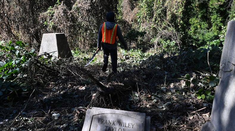 Yusuf Shabazz with Devine GA, clears up decades of kudzu and ivy choking the site of Hollywood Cemetery, 70 acres of abandoned grounds that had been left in neglect for decades, Friday, Oct. 24, 2025, in Atlanta. (Hyosub Shin / AJC)