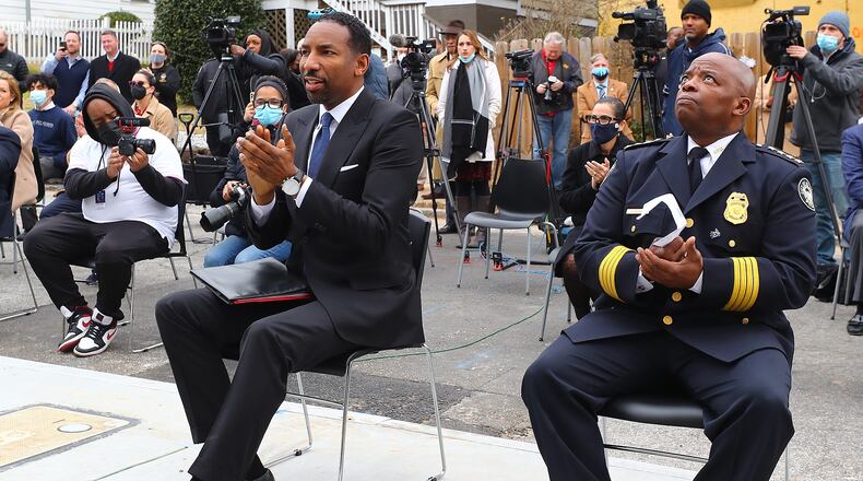 Atlanta Mayor Andre Dickens and Atlanta police Chief Rodney Bryant applaud speakers at the ribbon cutting for a new apartment complex for Atlanta Police recruits on Wednesday, Feb. 2, 2022, in Atlanta. (Curtis Compton / Curtis.Compton@ajc.com)