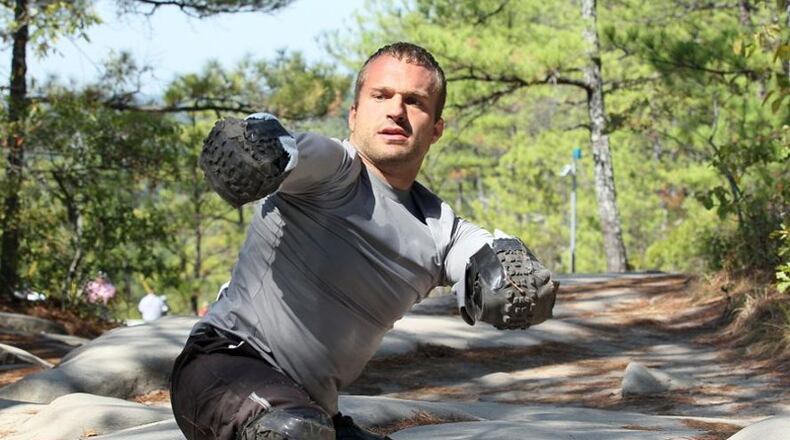 In this 2007 AJC file photo, Kyle Maynard takes a break from training on Stone Mountain.