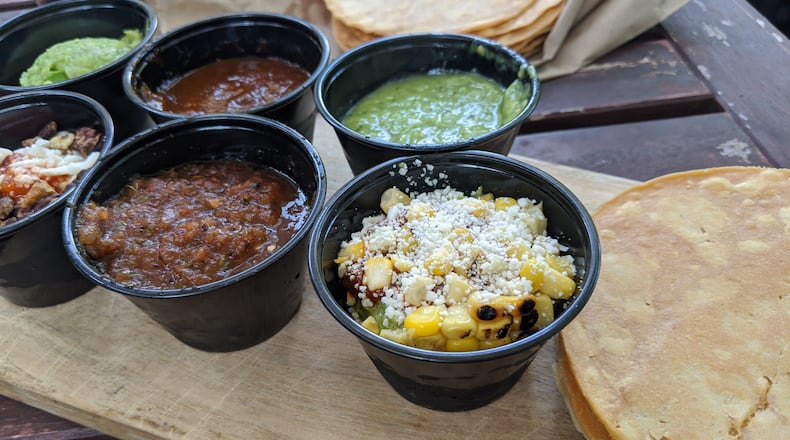 Alma Cocina's guacamole and salsa tasting features three guacamoles and three salsas, with a stack of housemade corn tostadas. Courtesy of Paula Pontes