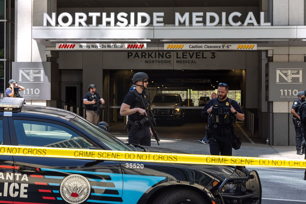 Law enforcement officers are seen on West Peachtree Street in front of the Northside Hospital Midtown medical office building, where five people were shot on May 3. One person died. (Arvin Temkar/The Atlanta Journal-Constitution)