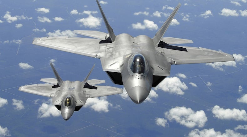 The world's most-advanced military aircraft has been out of production for four years. In this 2007 photo, two F-22 Raptors fly off the coast of Florida. (AP Photo/US Air Force, Thomas Meneguin)