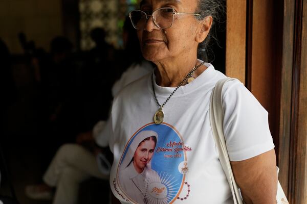 A believer attends a celebratory Mass for Blessed Maria Carmen Rendiles and wearing a T-shirt with her image at the Belen's school church where are their remains in Caracas, Venezuela, Monday, March 31, 2025. (AP Photo/Ariana Cubillos)