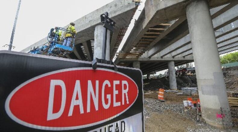 Crews work to repair the I-85 bridge. JOHN SPINK / JSPINK@AJC.COM