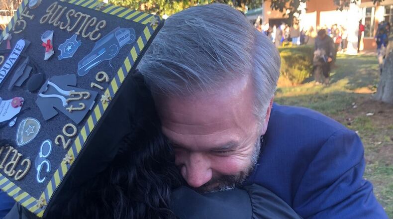 Kevin Esch embraces Latonya Young at her commencement ceremony at Georgia State University's Clarkston campus in December 2019. Esch paid a $693 student debt for Young. The two met a year earlier when Young was a Uber driver and Esch was one of her passengers. CONTRIBUTED.