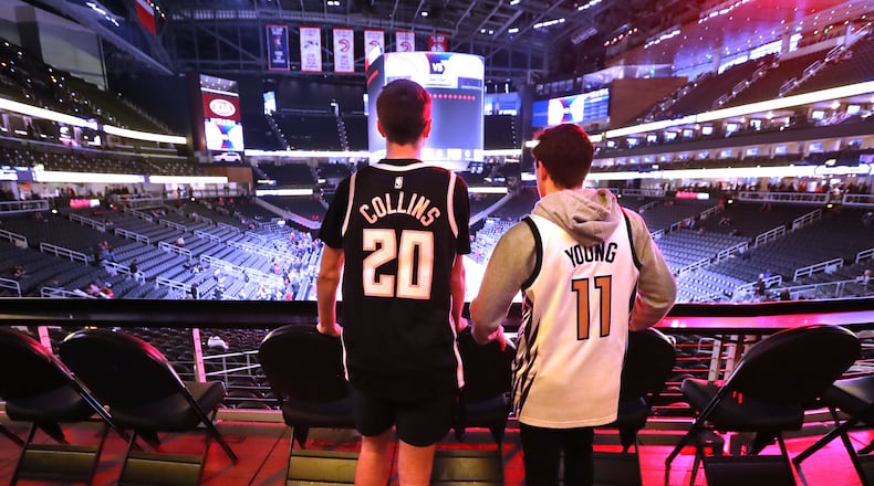 Hawks fans Robert Foushee (left) and Jon Cristofunelli are on hand to watch Atlanta face the N.Y. Knicks Wednesday, March 11, 2020, at State Farm Arena in Atlanta.