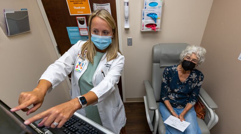 Lead Nurse Practitioner Lori Reed examines a Covid patient at Piedmont Pulmonary Covid Recovery Clinic in Atlanta in 2022. The U.S. Centers for Disease Control and Prevention mostly attributed the nationwide rise in life expectancy to fewer deaths caused by the infectious disease. (Steve Schaefer/AJC file)